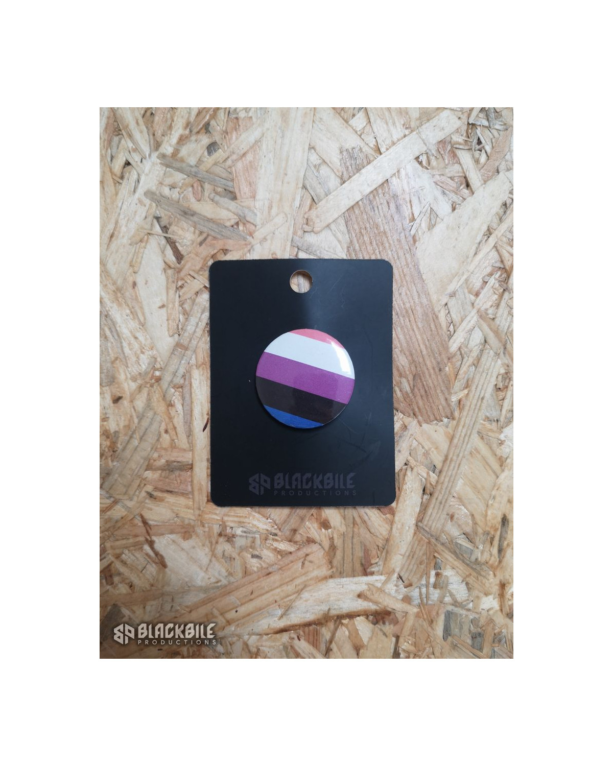 A small button badge in the colours of the genderfluid flag.