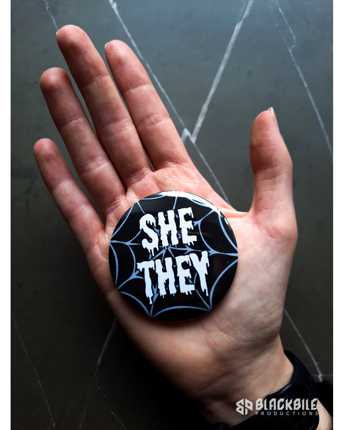 Big button badge She They pronouns spider web