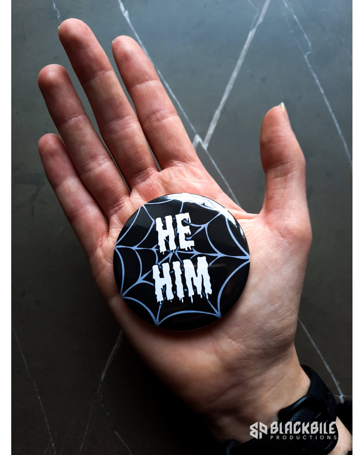 Big button badge He Him pronouns spider web